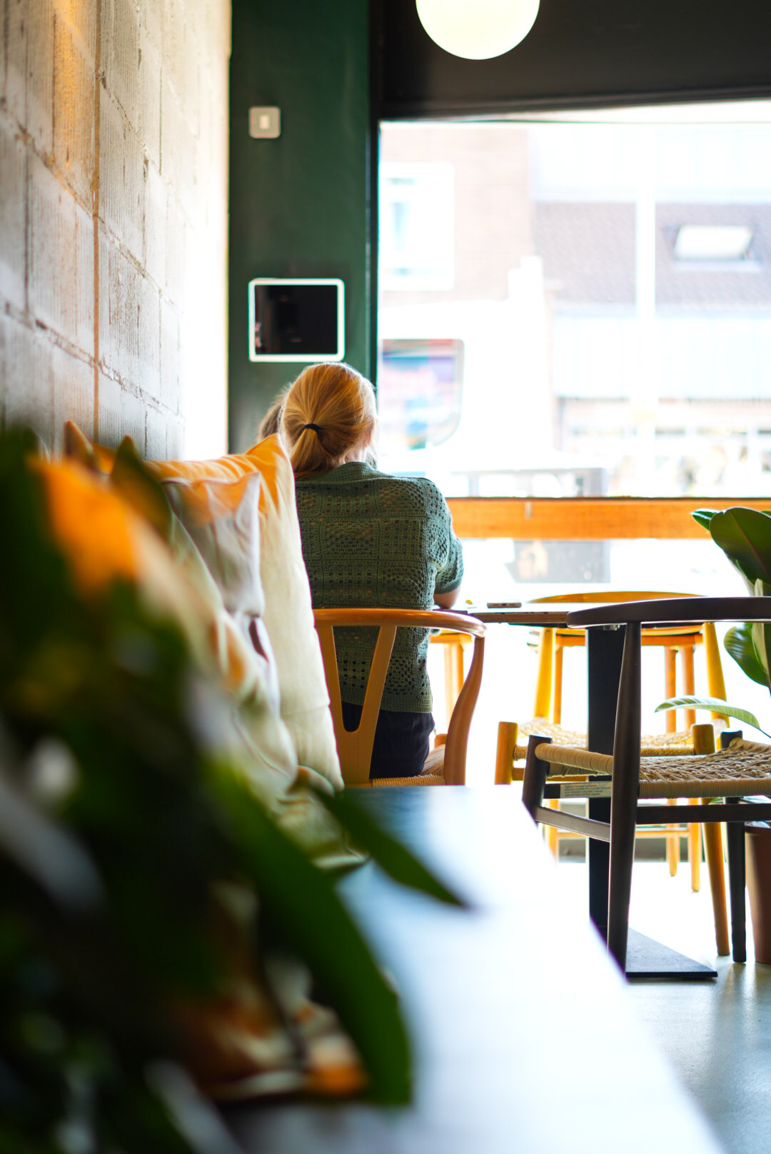 Customer sat at the window bench in the Broadstone café