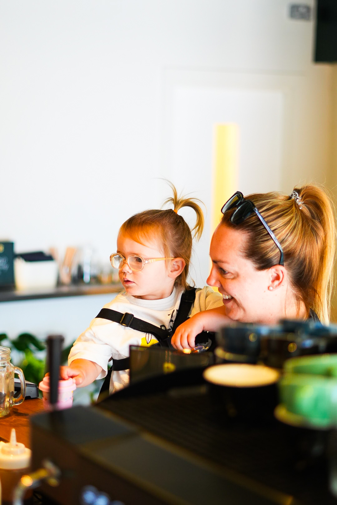 A toddler on the counter beside a smiling customer