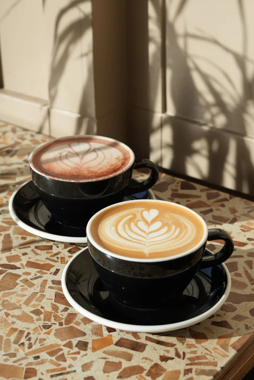 Hot chocolate behind a flat white