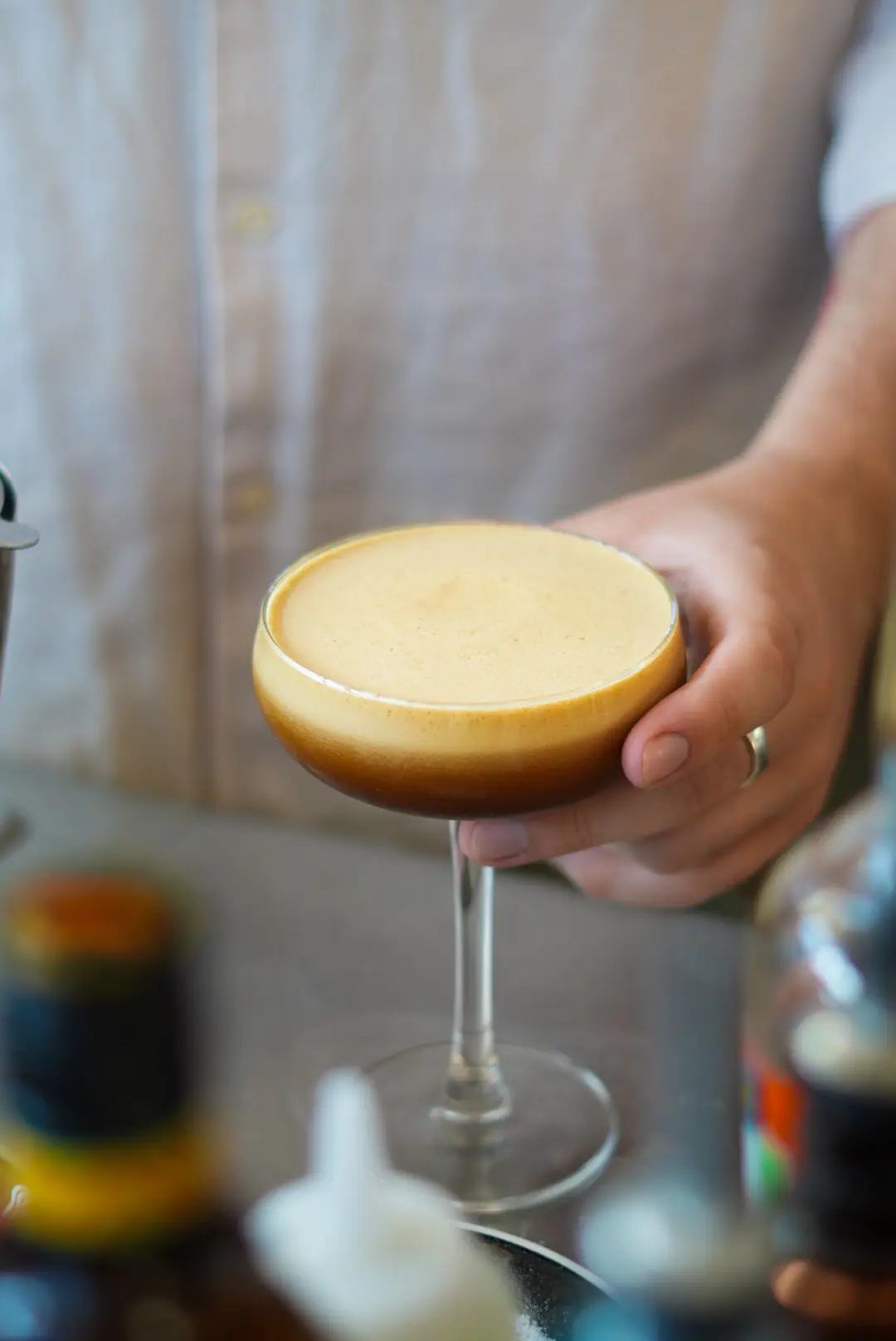 Espresso martini being handed across the bar