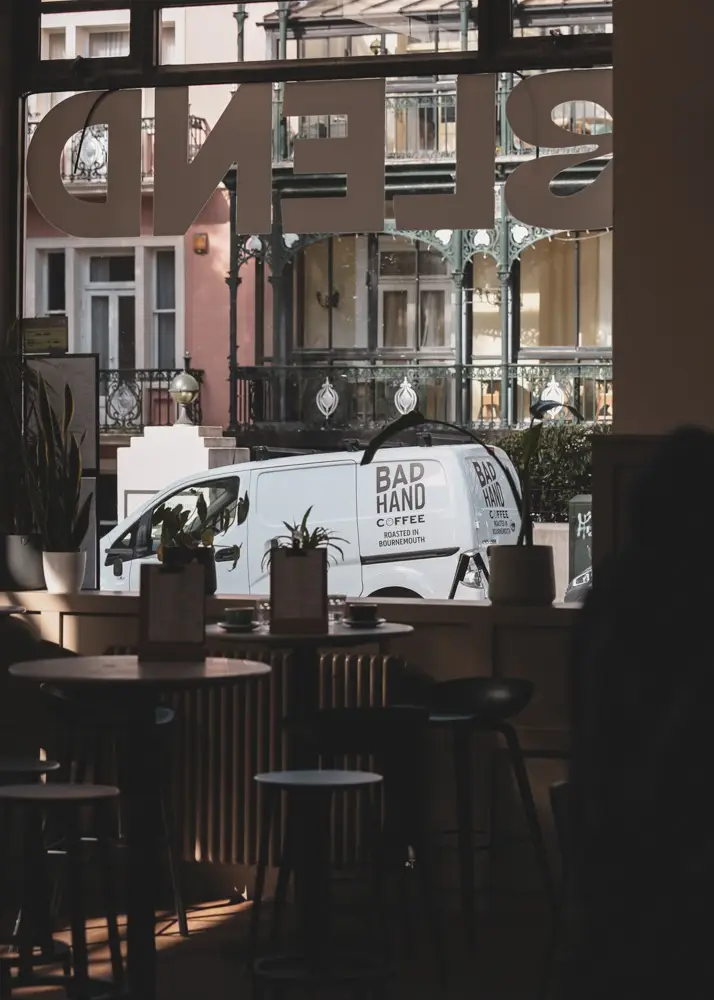 View through the BLEND window to a Bad Hand Coffee van outside